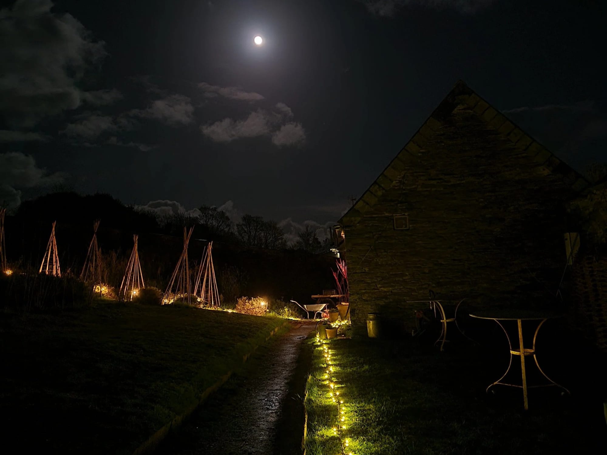 The Bothy at Prideaux Walled Garden lit up at night during Padstow Christmas Fayre