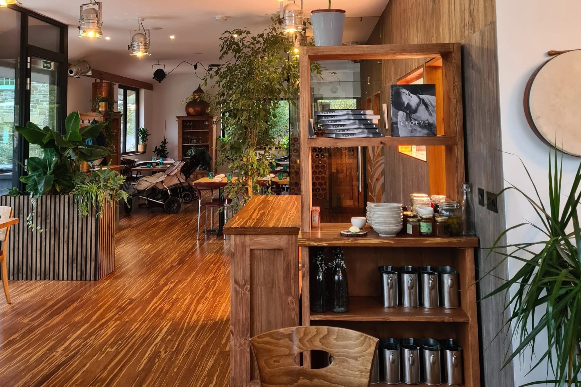 Wood furnishings inside Fern restaurant alongside chef Paul Welburn's cookbook Evolve