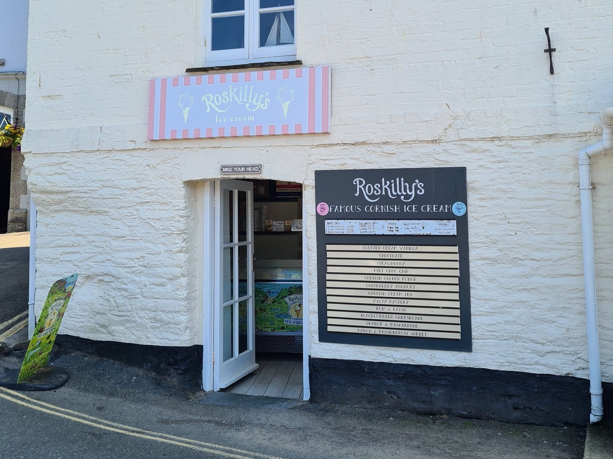 Roskilly's Cornish ice cream parlour with its striped pastel sign in Padstow