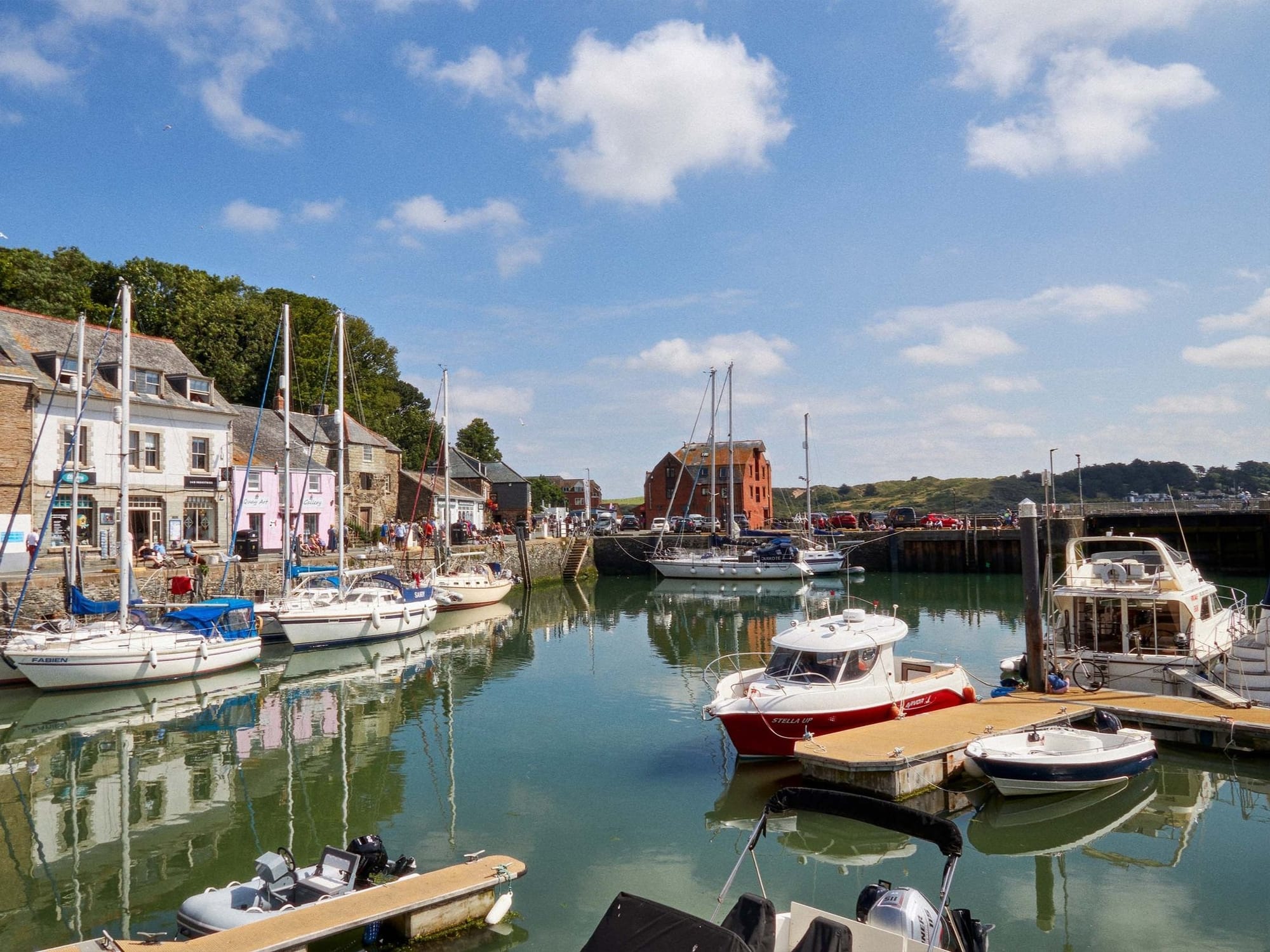 Boats moored in Padstow harbour on a sunny day