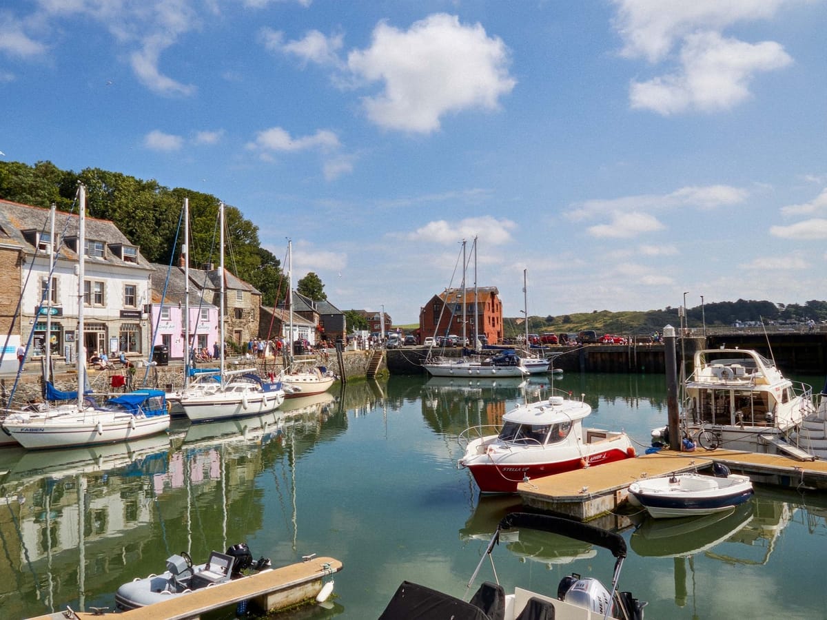 Boats moored in Padstow harbour on a sunny day, perfect weather for ice cream